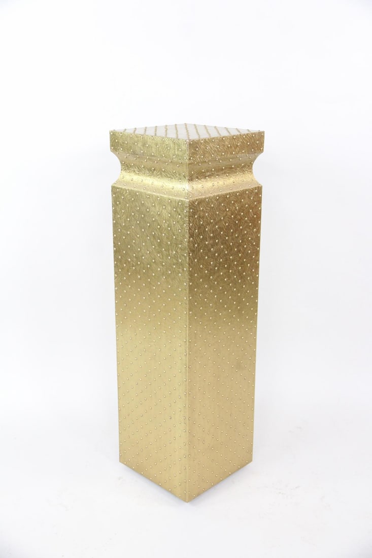 Hollywood Regency Pedestal by Global Views, Studio A: Studded Brass-Style Pedestal by Global Views, Studio A. This is a sculptural pedestal made of hand-embossed brass sheeting wrapped around a wooden form. The brass-tipped finishing nails form a