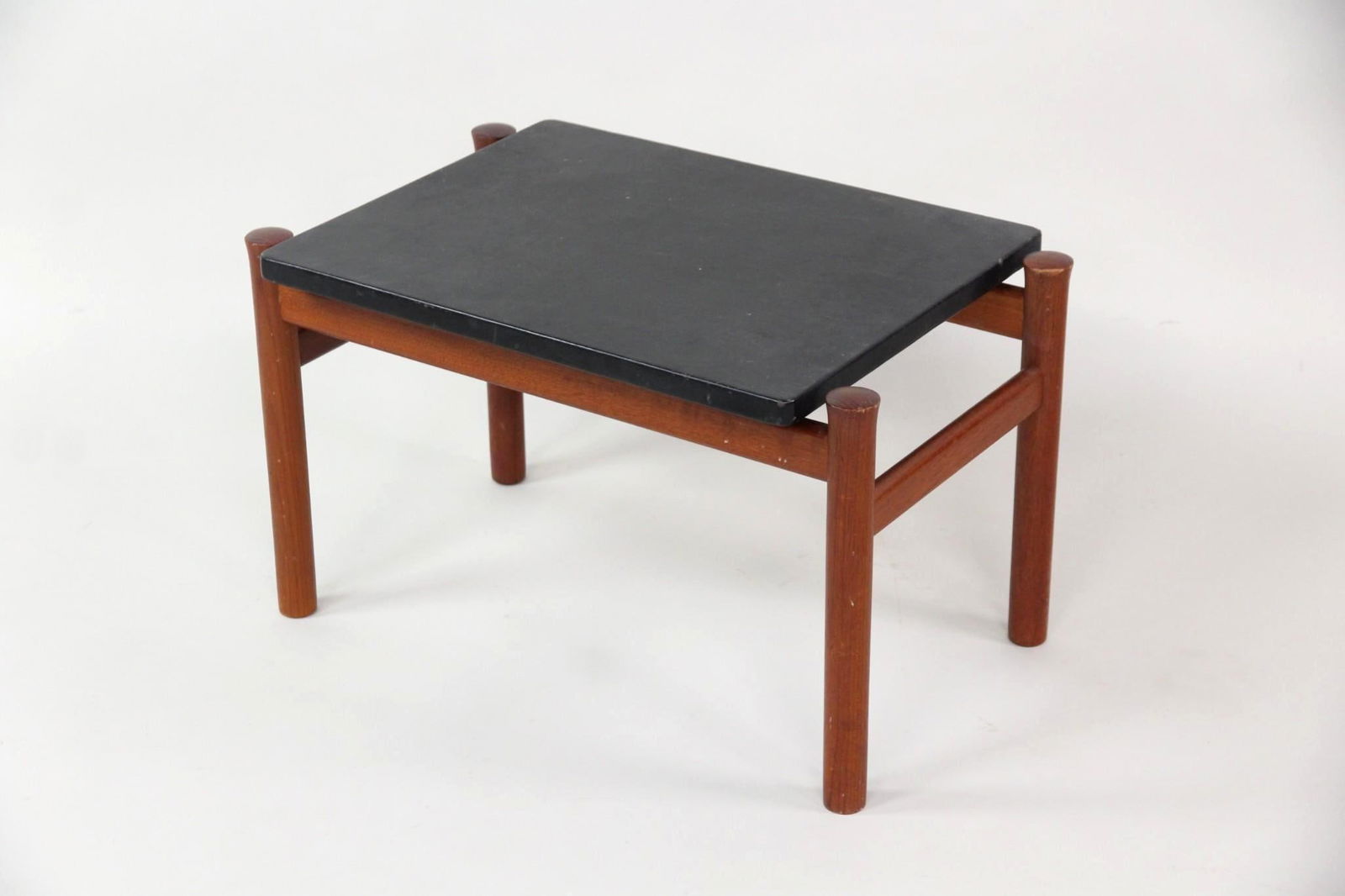 Fritz Hansen Floating Teak & Leather Side Table: Mid-century Modern Fritz Hansen Floating Teak & Leather Side Table. A small table with clean-lined teak frame and floating black leather top. Labeled to interior of frame, Fritz Hansen, Made in