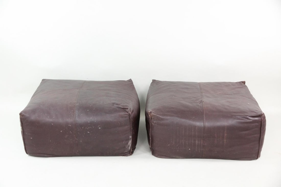 Pair of Leather Le Bambole Ottomans by Mario Bellini for B&B Italia: Pair of Leather Le Bambole Ottomans by Mario Bellini for B&B Italia. Chic, oversized brown leather ottomans from the Le Bambole Series, produced by B&B Italia. Stamped to bottom, Bellini, B&B Italia.D