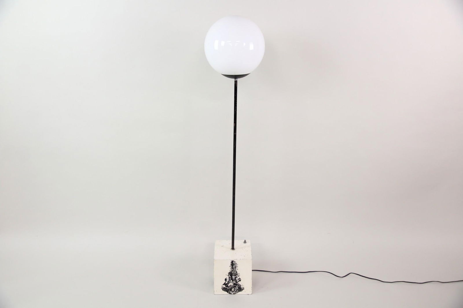 Metal and Glass Globe Lollipop Floor Lamp with Fornasetti Style Base: Mid-century Modern Metal and Glass Globe Floor Lamp with Fornasetti Style Base with Neoclassical Stencil. A metal lollipop form floor lamp with a glass globe shade and square wood base, painted white