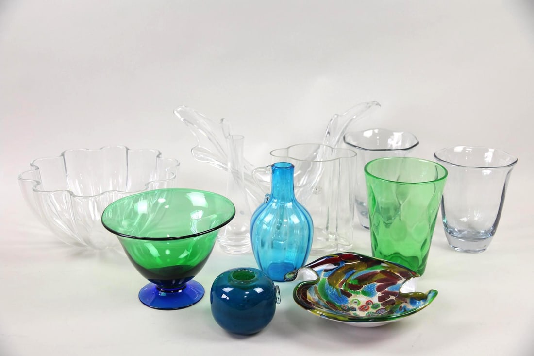 Lot of 11 Mid-Century Modern Glass Vessels, Murano: Lot of 11 Mid-Century Modern Glass Vessels, Murano. Includes a Murano dish with millefiori, a squat blue vase, a blue glass pitcher with handle, a clear sculptural centerpiece bowl, a green bowl with