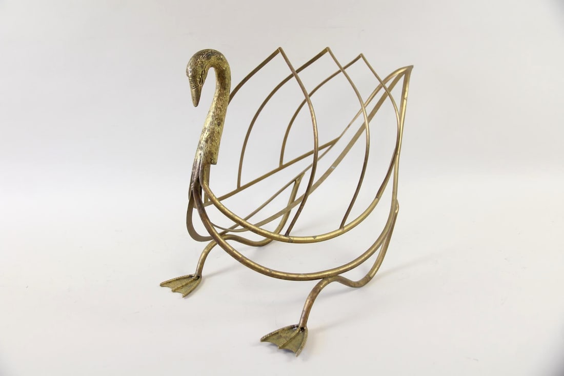 Brass Swan Magazine Rack, Maison Jansen: Mid-Century Modern Brass Swan Magazine Rack, Maison Jansen. A decorative rack featuring a detailed swan head and body with an open skeletal structure for holding magazines or newspapers. Unmarked, we