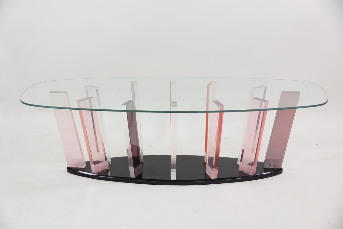Shlomi Haziza Postmodern Lucite & Glass Coffee Table: Shlomi Haziza Postmodern Lucite & Glass Coffee Table. Coffee table made with lucite support bars in pink, clear and purple, black base and clear glass top. Dimensions are 16.5 in h x 56 in w x 22.25