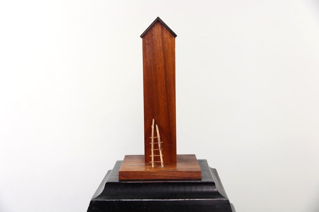 Ernest Chase House with Ladder Modernist Sculpture: Ernest Chase House with Ladder Modernist Sculpture. Minimalist sculpture made of wood, with a wooden house and ladder at the top, mounted on a black wooden box. Dimensions are 33 in h x 11 in w x