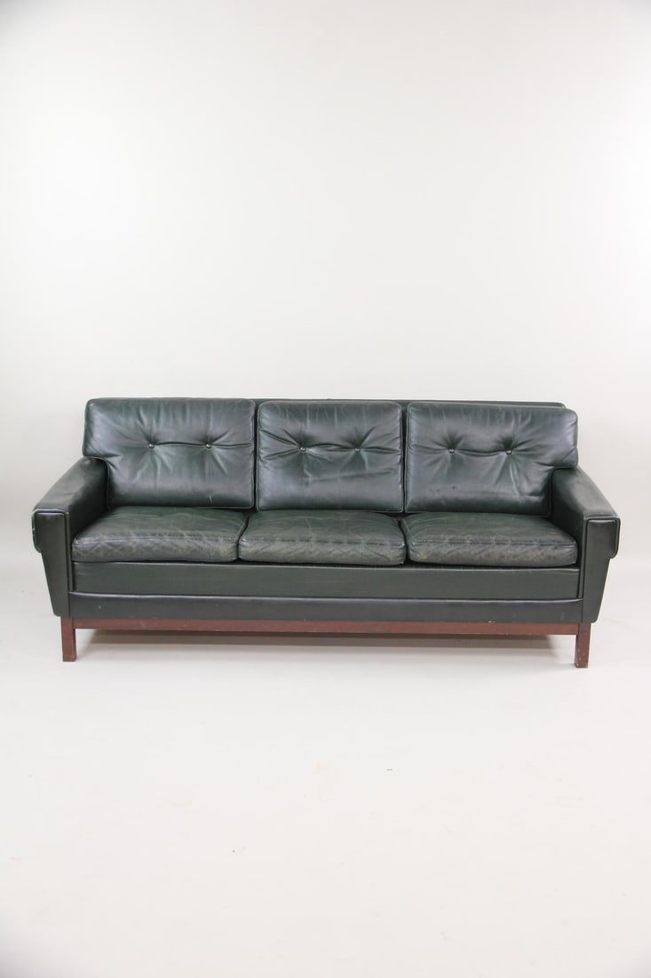 Art Deco Minimal Green Leather Sofa: Art Deco Minimal Green Leather Sofa. This mid century modern sofa has a simple art deco shape as well. It is nice patina green leather. Dimensions are 28.5 in h x 69.5in w x 32 in d. Condition is good