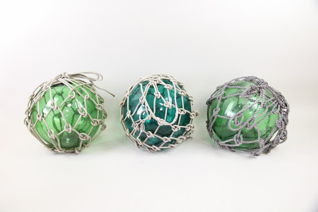Lot of 3 Japanese Glass Fishing Floats: Lot of 3 Japanese Glass Fishing Floats, Nautical Buoys. Threefishing floats, originally used to keep fishing nets afloat, made of hand blown green and blue glass spheres encased in rope netting. Dimen