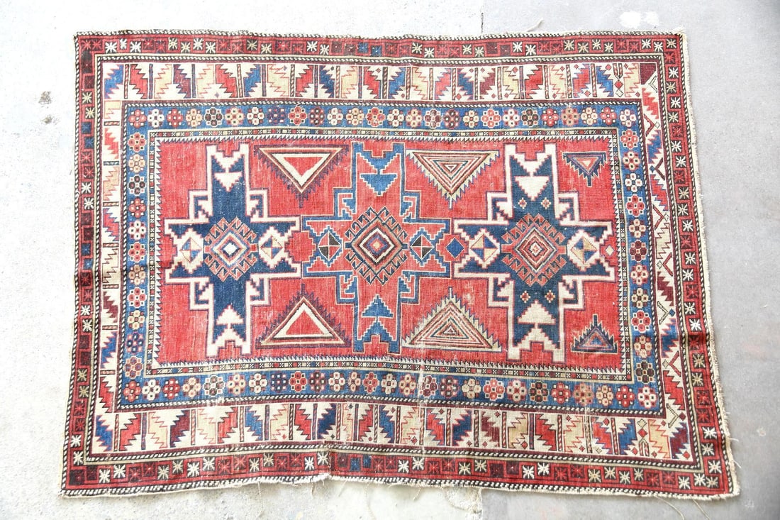 Caucasian Kazak Wool Rug, Lesghi Star: Caucasian Geometric Kazak Wool Rug, Lesghi Star. A handwoven rug with three central 'lesghi star' medallions and multiple surrounding borders in red, blue, & tan. Made of woolwith a flexible handle. 
