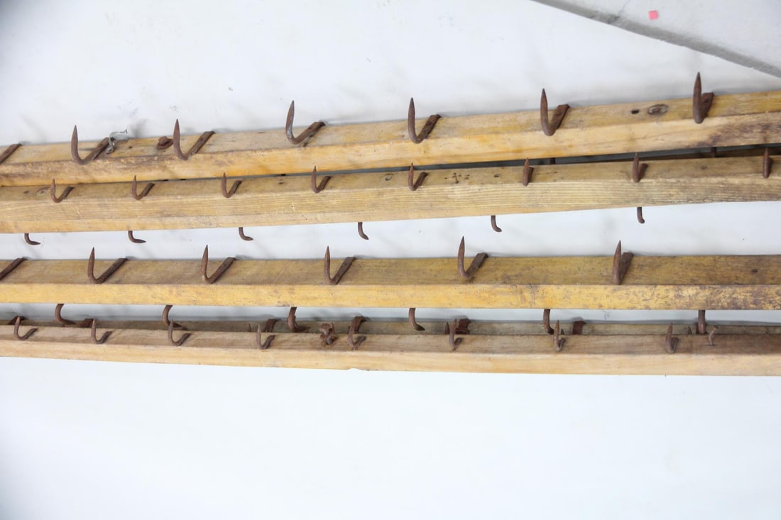Group of 6 Large Wrought Iron & Wood Butcher Shop Hooks: Group of 6 Industrial Large Wrought Iron & Wood Butcher Shop Hooks. Between 9 and 12.5 feet wide, six lengths of wood have wrought iron hooks attached. Dimensions are 109 to 125.5 in h x 4.25 to 9 in