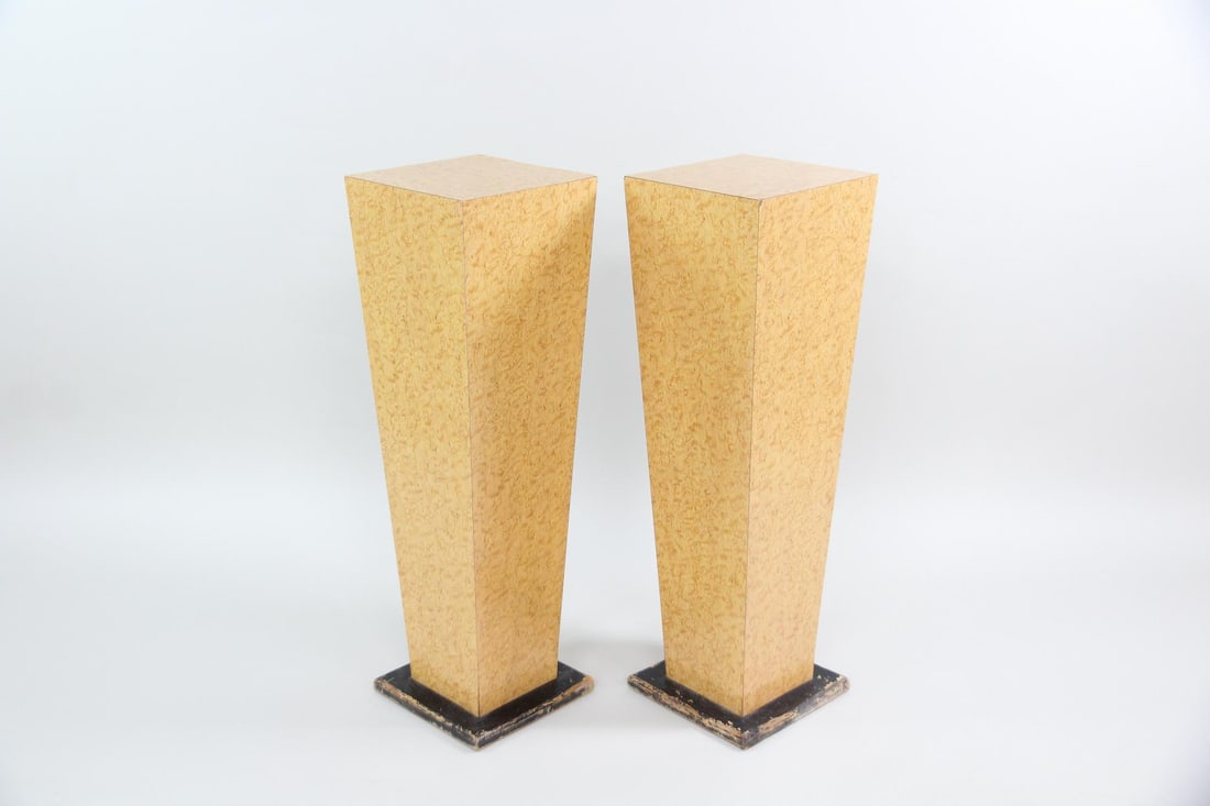 Pair of Postmodern Burl Pedestal Display Stands: Pair of Postmodern Burl Laminate Wood Pedestal Display Stands. Matching pair of pedestals with tapered bodies veneered in burl laminate and dark wood bases. Dimensions are 36.5 in h x 11.25 in w x 11