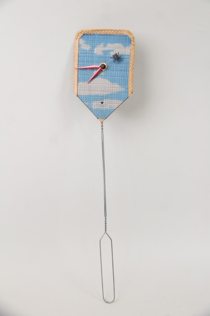 David Dear "Fly Clock," Kitcsh Fly Swatter: David Dear "Fly Clock," Kitcsh Fly Swatter. A clever clock design featuring a fly that "moves" around a real fly swatter. Designed by David Dear. Dimensions are 20.75 in h x 4.5 in w x 1.25 in d.