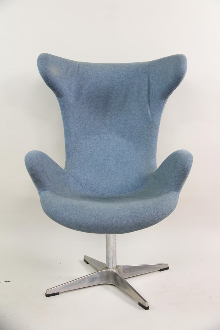 Mid-century Modern Egg Chair, Powder Blue: Mid-century Modern Egg Chair, Powder Blue. This lounge chair has a shell-like frame, upholstered in powder blue fabric, with a four-star aluminum base. Dimensions are 43 in h x 29 in w x 32 in d.