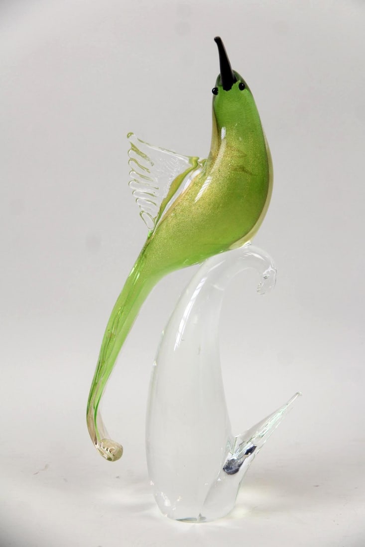15 in Murano Glass Bird of Paradise Sculpture: Mid-Century Modern 15 in Murano Glass Bird of Paradise Sculpture. Larger than average Murano glass bird of paradise sculpture with green and gold-flecked glass, on a clear glass perch. Dimensions are 