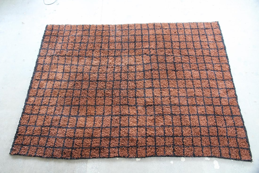 Moroccan Wool Shag Rug, Black & Brown Grid: Minimalist Moroccan Wool Shag Rug, Black & Brown Grid. A wool rug woven with a brown & black grid pattern. Soft with a plush, shaggy pile. Dimensions are 123 in h x 87.5 in w x 1.25 in d. Condition is