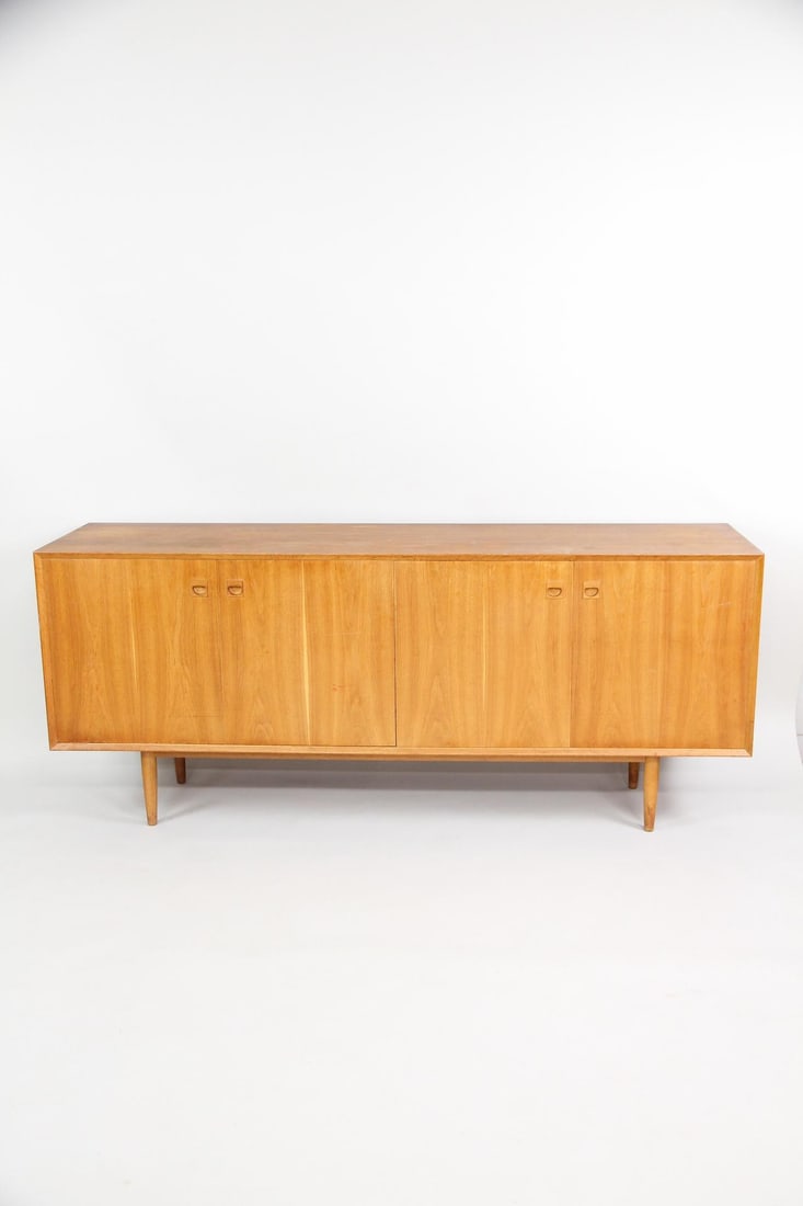 Erik Brouer Teak Credenza with Bi-Fold Doors: Danish Mid-Century Modern Erik Brouer Teak Sideboard Credenza. Sideboard in teak designed by Erik Brouer for Brouer Møbelfabrik. Featuring folding doors, 4 sliding drawers (2 with green felt) and