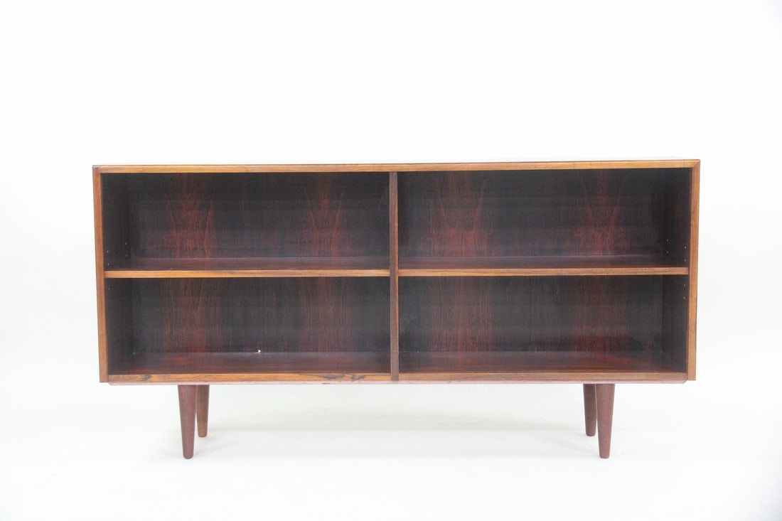 Lowboy Adjustable Bookcase, Rosewood: Danish Mid-century Modern Lowboy Adjustable Bookcase, Rosewood. A minimal bookcase with open, adjustable shelving. Made of beautifully grained rosewood with tapered legs. Dimensions are 30.25 in h x 5