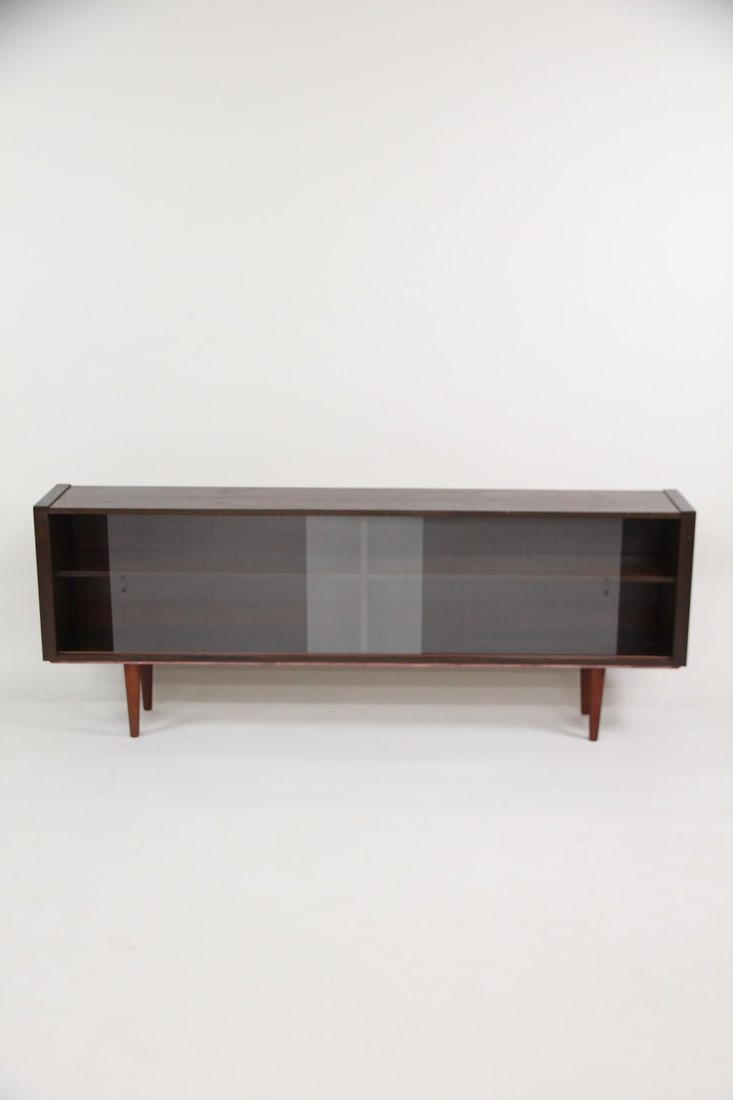 Skovby Dark Oak Bookcase with Glass Doors: Danish Mid-Century Modern Skovby Dark Wood Bookcase with Glass Doors. Wide book shelf in dark finished wood and glass doors. Marked Skovby. Dimensions are 29.5 in h x 77 in w x 12 in d. Condition is g