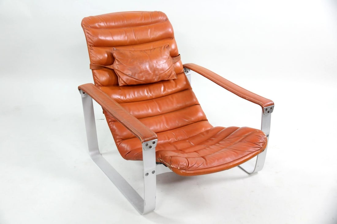 Ilmari Lappalainen "Pulkka" Lounge Chair, Orange Leather: Finnish Modern Ilmari Lappalainen for Asko "Pulkka" Lounge Chair, Leather. A fantastic lounge chair with a channeled orange leather seat sitting freely within an aluminum frame. With attached leather