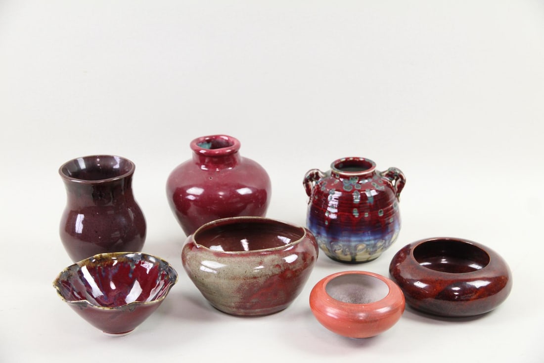 Group of 7 Red Oxblood & Flambe Pottery Vessels: Group of 7 Oxblood & Flambe Pottery Vessels. Includes a variety of vases and bowls in deep red oxblood and flambe red glazes. Dimensions are 2.5 in h x 4.75 in w x 4.75 in d to 7 in h x 6.25 in w x