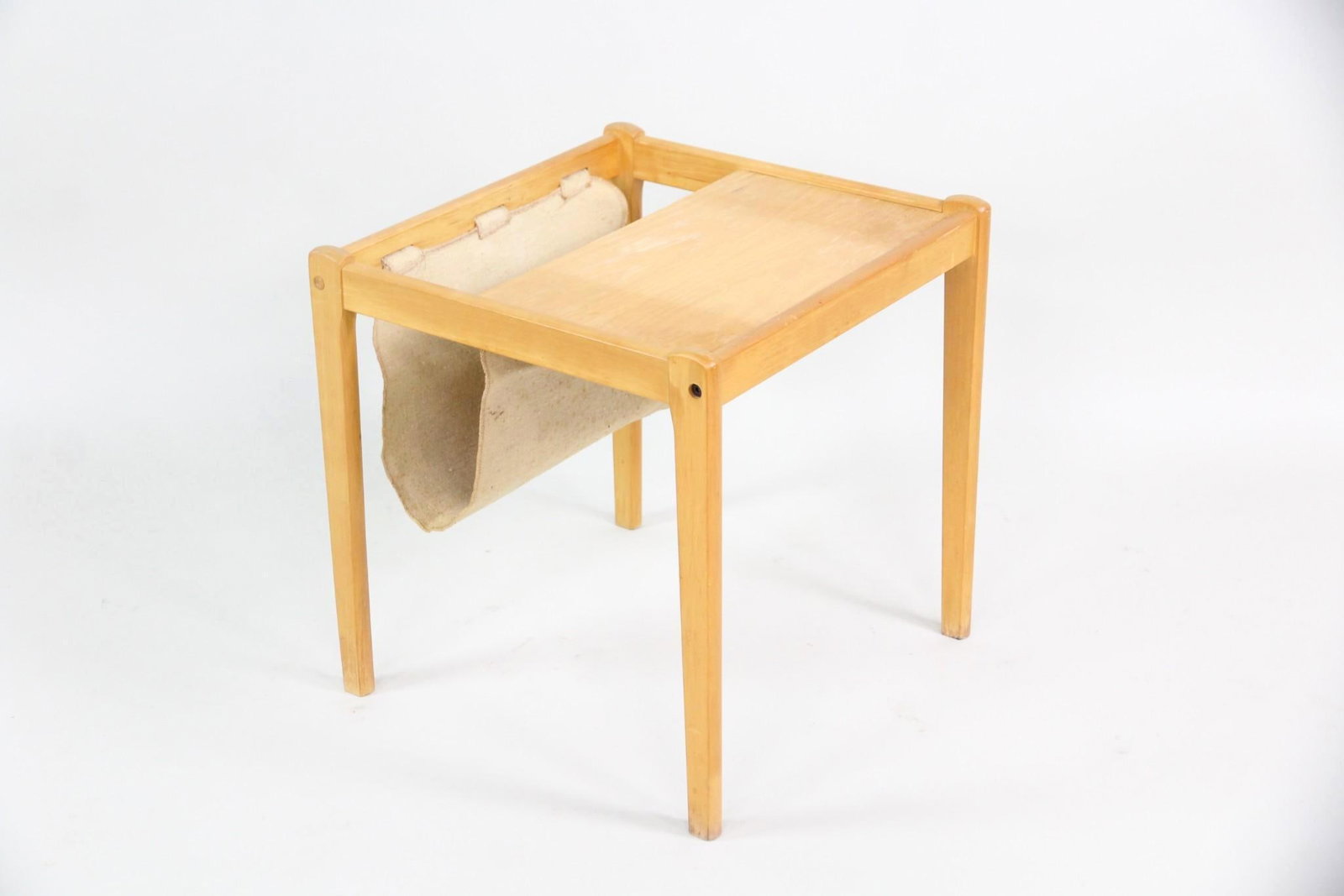 Wood & Canvas Sling Magazine Table by BRDR Furbo: Danish Mid-century Modern Wood & Canvas Sling Magazine Rack Table by BRDR Furbo. A small table made of light wood, likely oak, with a sling magazine holder in natural canvas. Dimensions are 18.25 in