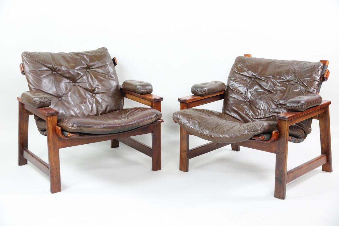 Pair of Danish Leather & Rosewood Lounge Chairs: Pair of Danish Modern Leather & Rosewood Lounge Chairs. Matching pair of chairs with bent rosewood frames and removable brown leather seats, arm cushions and backs. Dimensions are 30 in h x 29.5 in w