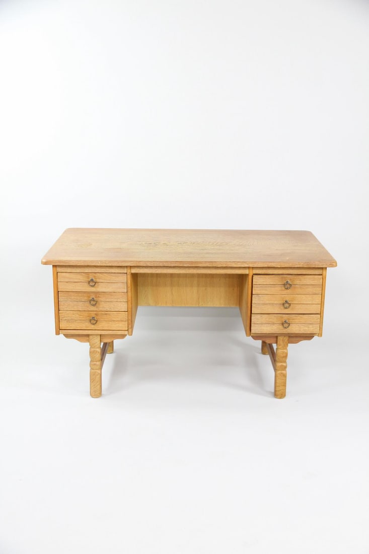 Danish Oak Executive Desk, Henning Kjaernulf: Danish Brutalist Henning Kjaernulf Oak Executive Desk. Oak desk with carved legs, 6 drawers on the front and a bookcase on the opposite side. Dimensions are 29 in h x 55 in w x 29.5 in d. Condition