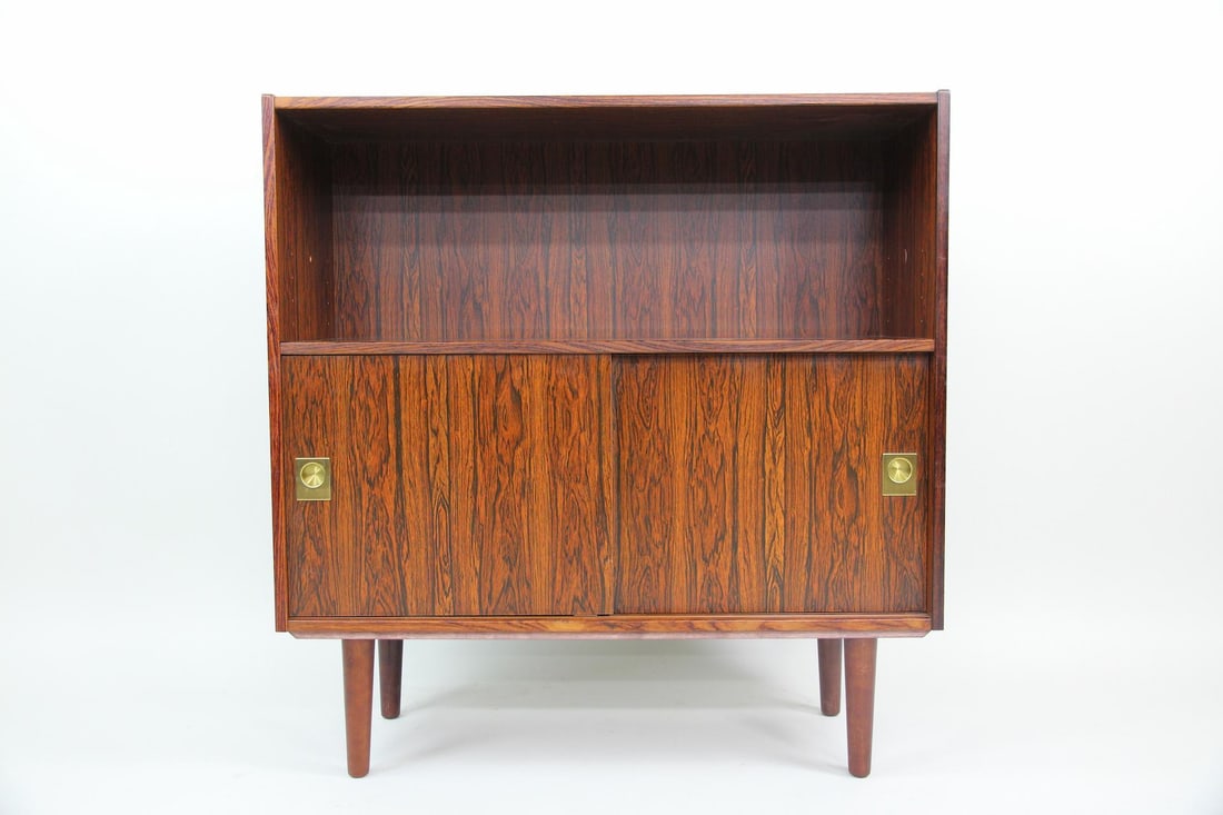 Rosewood Bookcase Cabinet with Sliding Door: Danish Mid-Century Modern Rosewood Bookcase Cabinet with Sliding Door. Bookcase veneered in attractive rosewood with a shelf on top and sliding door shelved cabinet on the bottom. Dimensions are 34