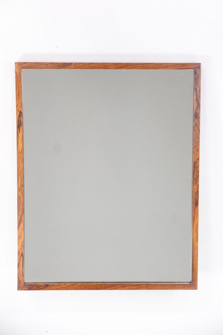Scandinavian Minimalist Rosewood Mirror: Danish Mid-Century Modern Scandinavian Rosewood Mirror. Wall mirror with thin rosewood frame. Dimensions are 33 in h x 26.5 in w x 1.25 in d. Condition is good with some scuffs to the top of the wood