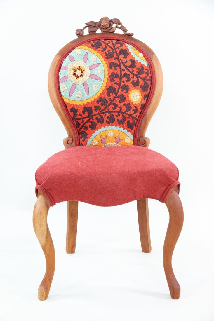 Louis XVI Armchair with Boho Upholstery: Louis XVI Style Armchair with Boho Upholstery. French style wooden dining chair with carved floral details and red, blue and yellow upholstery. Chair has been reupholstered. Dimensions are 38 in h x