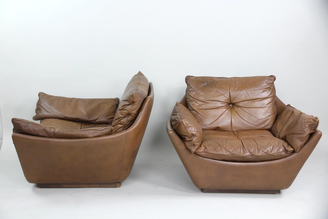 Pair of Sculptural Club Chairs, Brown Leather: Pair of Mid-century Modern Sculptural Club Chairs, Brown Leather. A pair of sculptural lounge chairs with low, angular shells and tufted cushions. Upholstered in soft brown leather. Dimensions are 24.