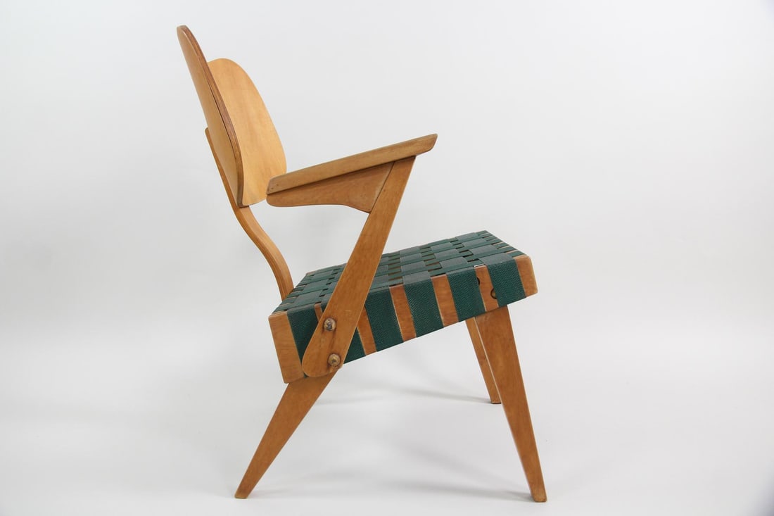 Russell Spanner "Ruspan" Lounge Chair: Russell Spanner Mid-Century Modern "Ruspan" Lounge Chair. Featuring a plywood backrest and green woven webbing seat. Dimensions are 31 in h x 22 in w x 22 in d. Condition is good with some discolorati