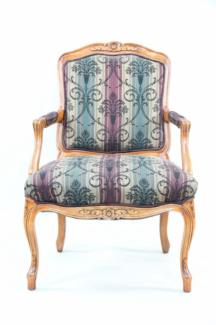 Louis XV Armchair with Striped Upholstery: Louis XV Style Armchair with Striped Upholstery. French style armchair with carved floral details and purple, tan and green striped upholstery. Chair has been reupholstered. Dimensions are 37 in h x 2
