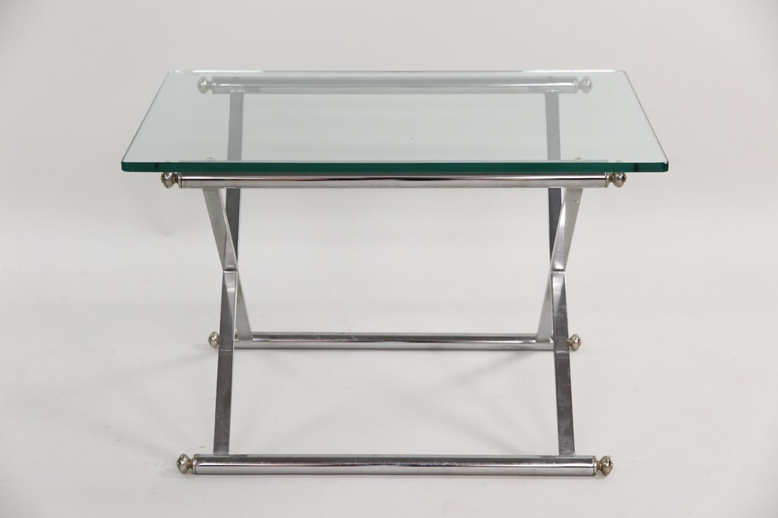 Hollywood Regency X-Base Chrome & Glass Coffee Table: Mid-Century Modern Hollywood Regency X-Base Chrome & Glass Coffee or Side Table. Low table with a chrome X-frame base with brass accents and a glass top. Dimensions of the base are 21 in h x 20.5 in w