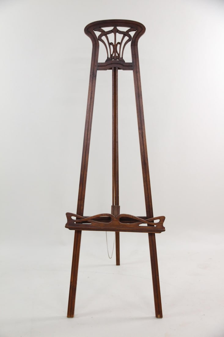 Arts & Crafts Teak Artist's Easel: Arts & Crafts Teak Artist's Easel. A beatiful art studio easel, with A-frame construction and hinged back leg. It features caved teak wood with fluid, scrolling patterns. Dimensions are 61.75-68.5 in
