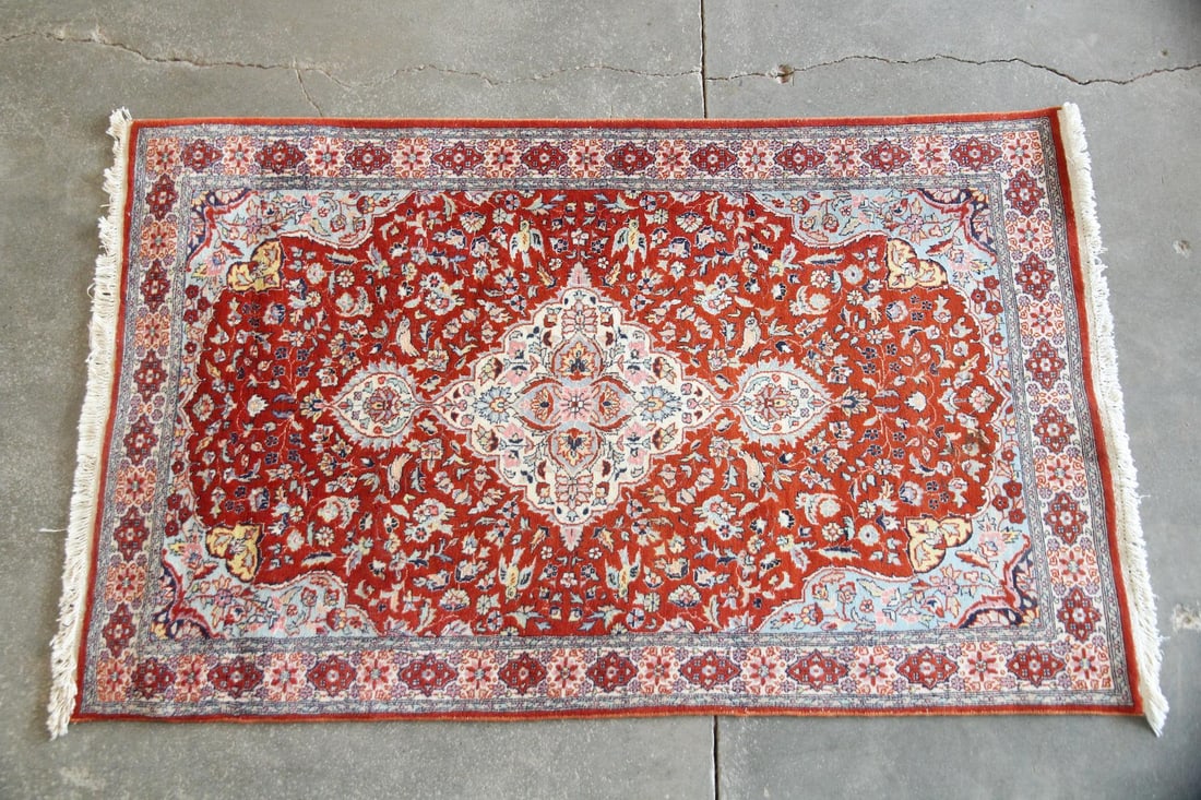 Persian Kerman Style Rug, Wool & Cotton: Persian Kerman Style Rug, Wool & Cotton. This Persian style rug features an intricate white central medallion surrounded by intricate floral motifs on an orange field. Wool on cotton, made in