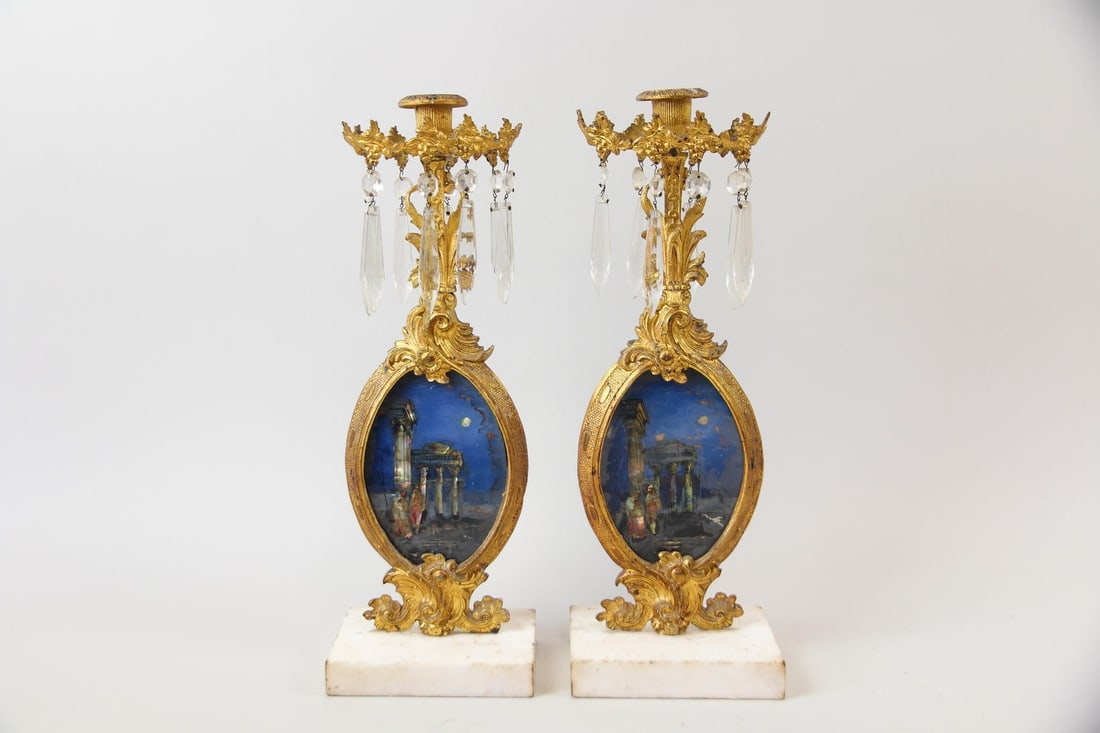 Pair of Napoleon III Gilt Bronze Candleholders with Reverse Painted Glass Scenes: Pair of French Gilt Bronze Ormulu Candleholders with Reverse Painted Glass Scenes. Matching pair of ornate candle holders in ormulu with crystal prisms and reverse-painted glass miniatures depicting a