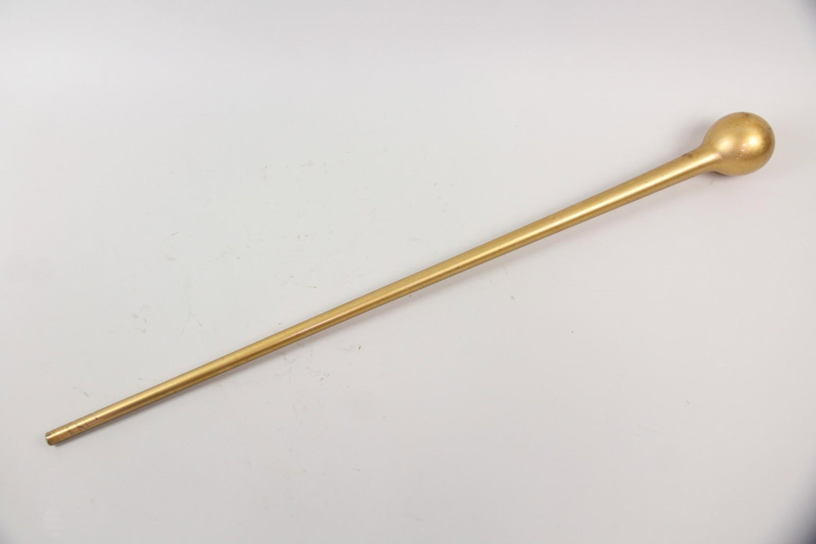 Gilt Free-Blown Glass Walking Stick, Parade Staff: Gilt Free Blown Glass Walking Stick, Parade Staff. Blown glass walking stick or parade staff, with gold finish on the interior. Dimensions are 37 in h x 3.25 in w x 3.25 in d. Condition is good with m
