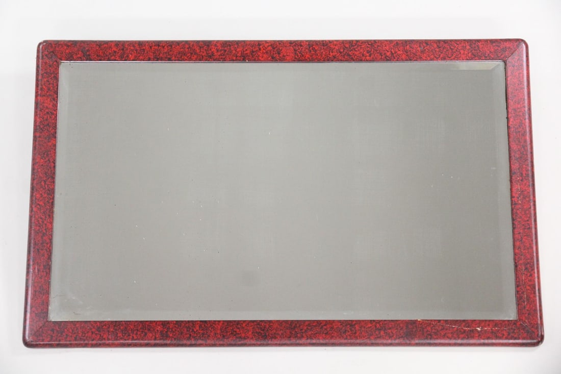Red Lacquered Beveled Mirror: Red Lacquered Beveled Mirror. Rectangular beveled mirror in a red and black lacquered wooden frame. Dimensions are 28 in h x 44 in w x 1.5 in d. Condition is fair with a crack in the frame. Not