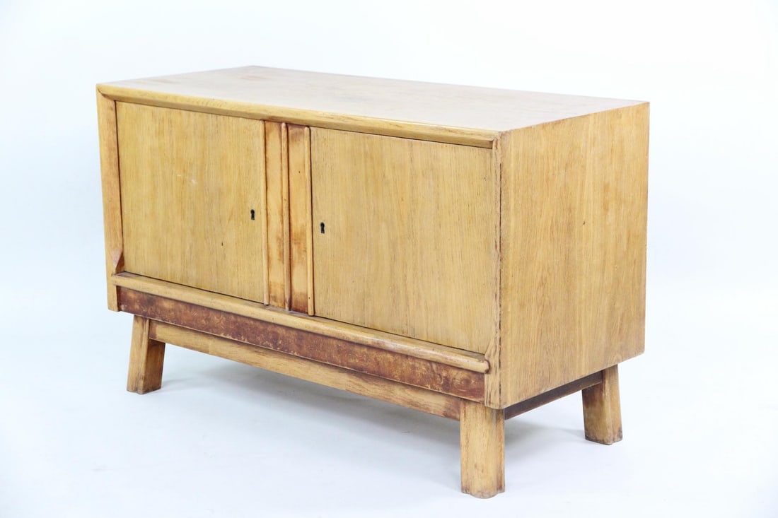 Art Deco Wood 2-Door Cabinet: Danish Mid-Century Modern Blonde Wood Cabinet. Two door cabinet with 2 red felt lined drawers and slanted carved feet. Dimensions are 26 in h x 41.5 in w x 18 in d. Condition is good with some minor m