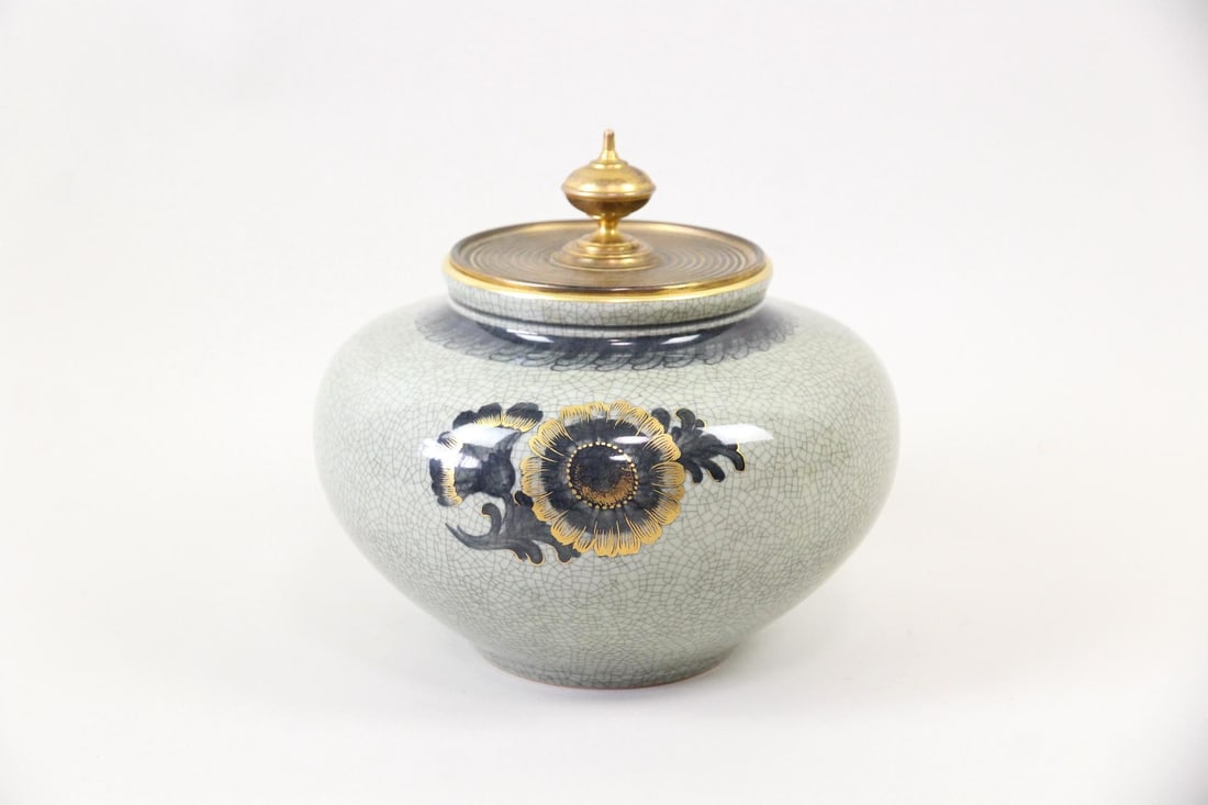 Royal Copenhagen Lidded Urn, Crackle Porcelain: Royal Copenhagen Lidded Urn, Crackle Porcelain. This elegant ceramic urn features a pale green crackle glaze decorated with a stylized, gold floral motif. It has by a finely detailed metal lid, likely