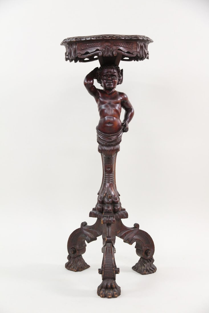 Carved Wood Figural Putti Fern Stand with Devil: Baroque Carved Wood Figural Putti Plant Stand with Devil, Display Pedestal. Ornate carved stand features a carved devil with a cherubic body. Dimensions are 40 in h x 15 in w x 17 in d. Condition is g