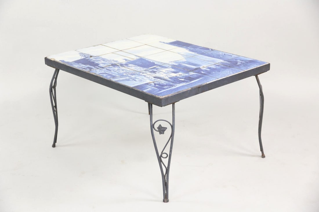 Dutch Delft Pictorial Tile Table, After C. Springer: Dutch Delft Pictorial Tile Table, After C. Springer. A table composed of 20 hand-painted blue & white Delft tiles depicting a town scene, after by the painter Cornelis Springer. It has a wrought iron 