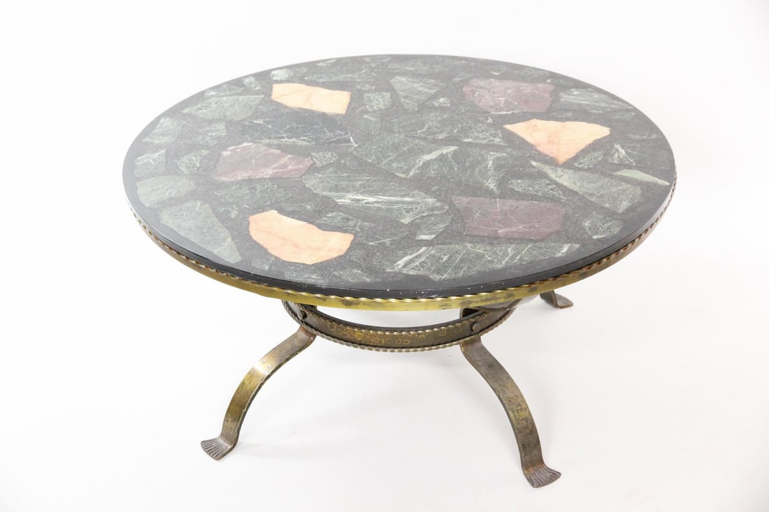 Wrought Iron Coffee Table with Faux Terrazzo Top: Mid-Century Modern Neoclassical Wrought Iron Coffee Table with Faux Terrazzo Top. Round table with brass or bronze plated wrought iron base and unusual multicolor terrazzo top with chunks of stone emb