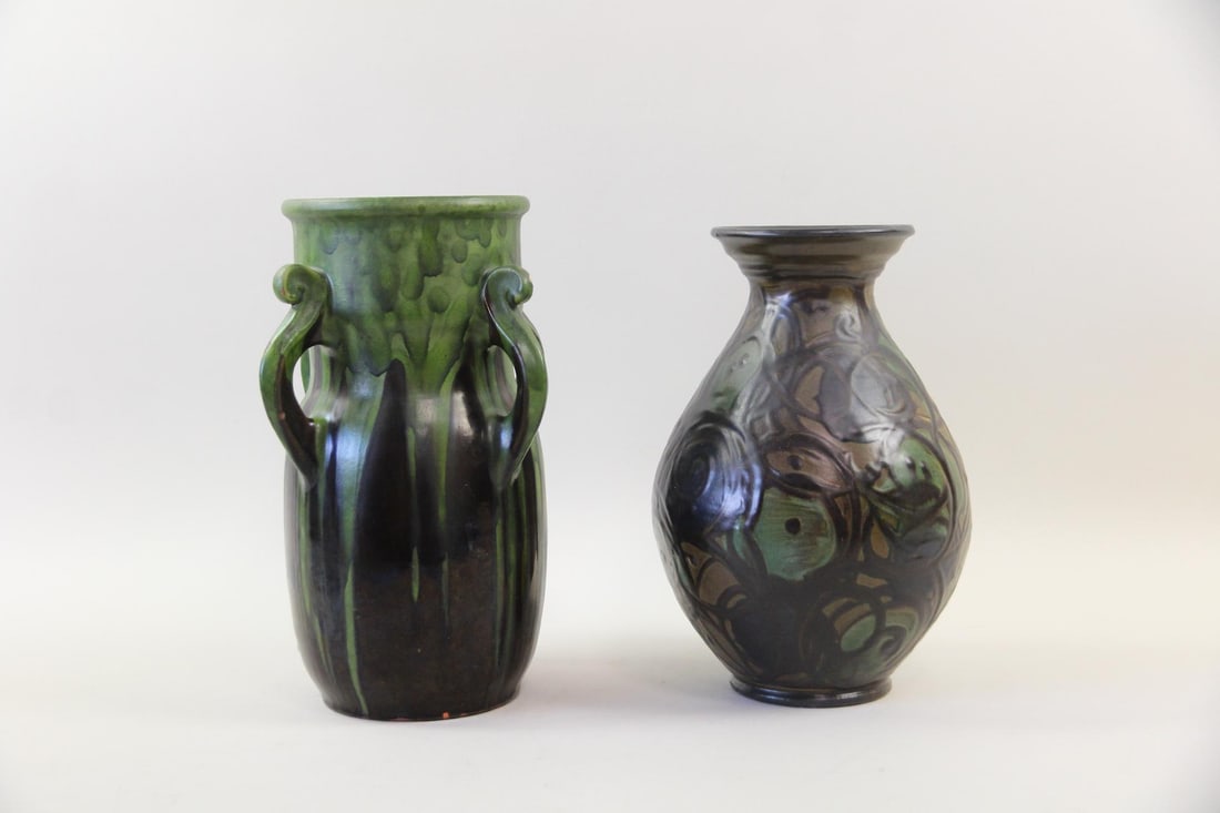 Pair of Herman A. Kahler Studio Pottery Vases: Pair of Herman Kahler Studio Pottery Vases. Includes an Art Nouveau handled vase by featuring a vibrant green drip overlay glaze dropping into a deep brown base and a slip-trailed ovoid vase with