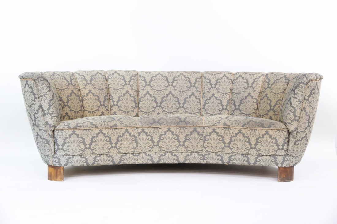 Blue Damask Banana Sofa: Danish Mid-Century Modern Blue Damask Banana Sofa. Large sofa upholstered in navy blue damask fabric, with channeled back and piping details. Dimensions are 28 in h x 80 in w x 41 in d. Seat height
