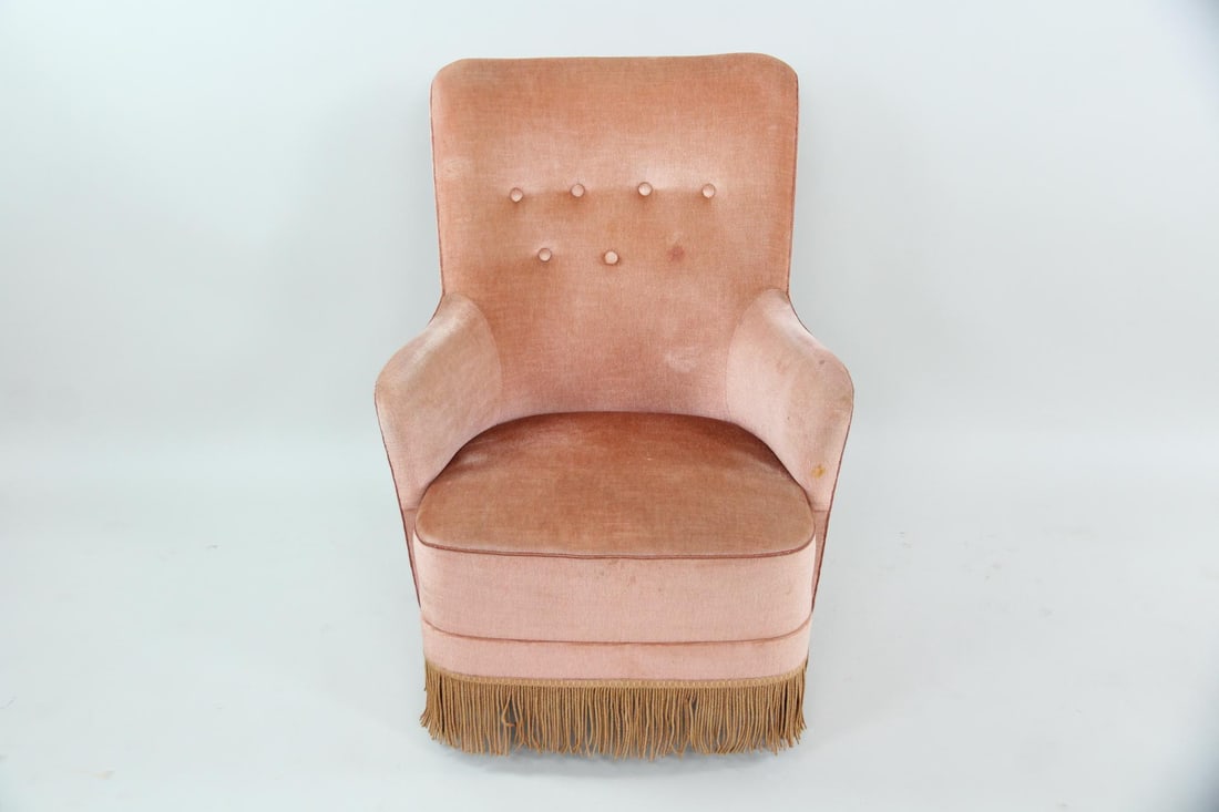 Danish Modern Armchair, Pink Velvet with Fringe: Danish Mid-century Modern Armchair, Pink Velvet with Fringe. A highback armchair with salmon-pink velvet upholstery, tufted buttons, and brown fringed skirt. Dimensions are 35 in h x 27 in w x 32 in