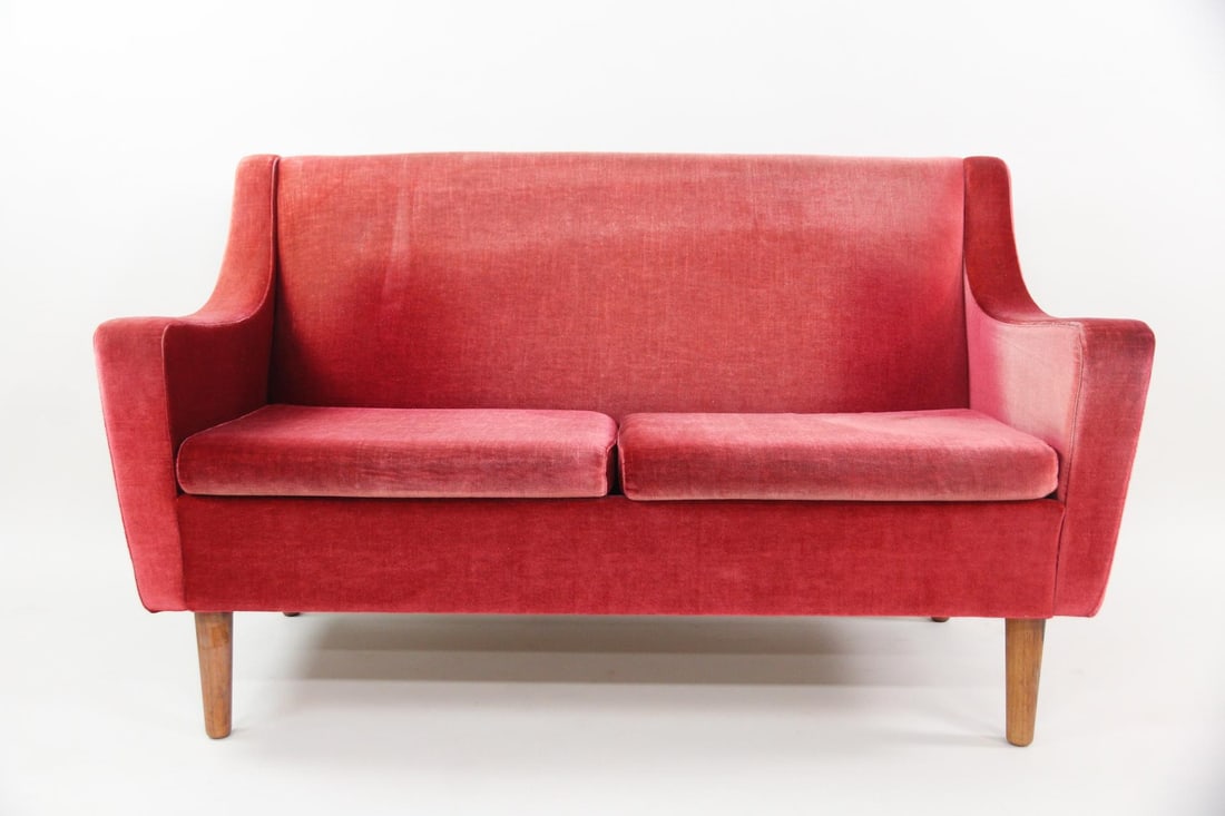 Danish Modern Red Velvet Settee: Danish Mid-century Modern Red Velvet Sofa Settee. Lovely 2-seater sofa with pinkish red velvet upholstery and tapered wooden legs. It has gently sloped arms and minimalist silhouette. Dimensions are
