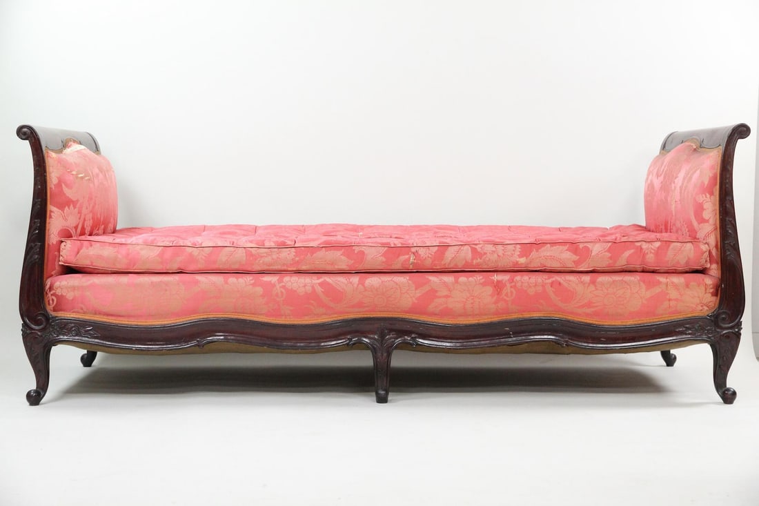 19th C. French Louis XV Silk Upholstered Daybed: French Louis XV Style Carved Wood Daybed with Silk Upholstery. Elegant daybed with carved dark wood frame, upholstered in pink silk with floral motif. Dimensions are 32 in h x 33.5 in w x 83 in d. Con