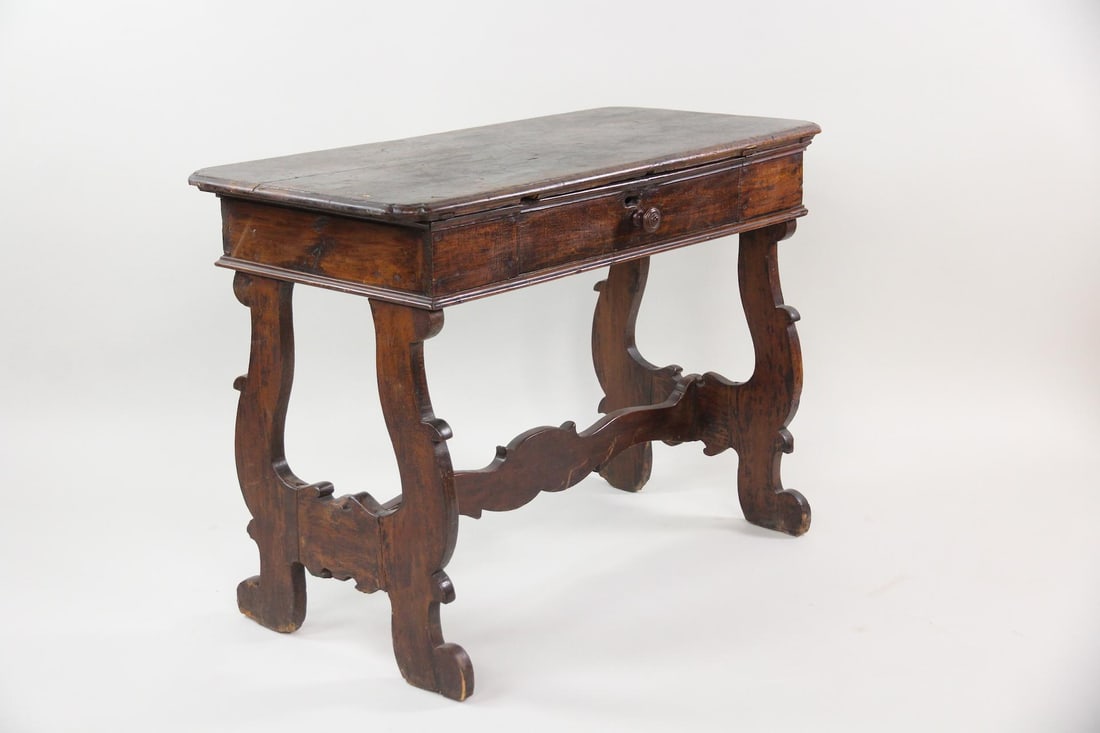 19th C. Fratino One-Drawer Console Table: 19th C. Fratino One-Drawer Console Table. A singled-drawer table or petite desk featuring a thick top supported by carved lyre-shaped legs. Made of dark, rich wood, possibly walnut. Dimensions are 31.