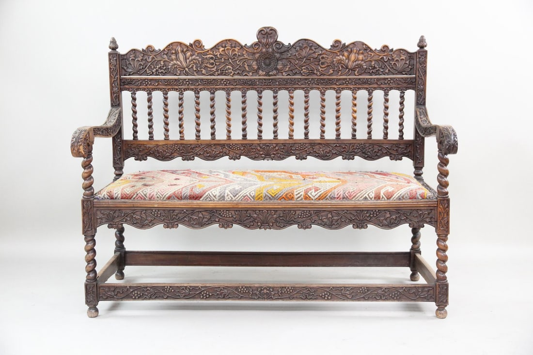 Barley Twist Hall Bench with Embroidered Kilim Seat: Victorian Hall Bench, Barley Twist Carved Wood & Kilim Upholstery. A hall bench made of wood with intricate floral carvings. It features distinctive barley twist legs and arm supports paired with a ki