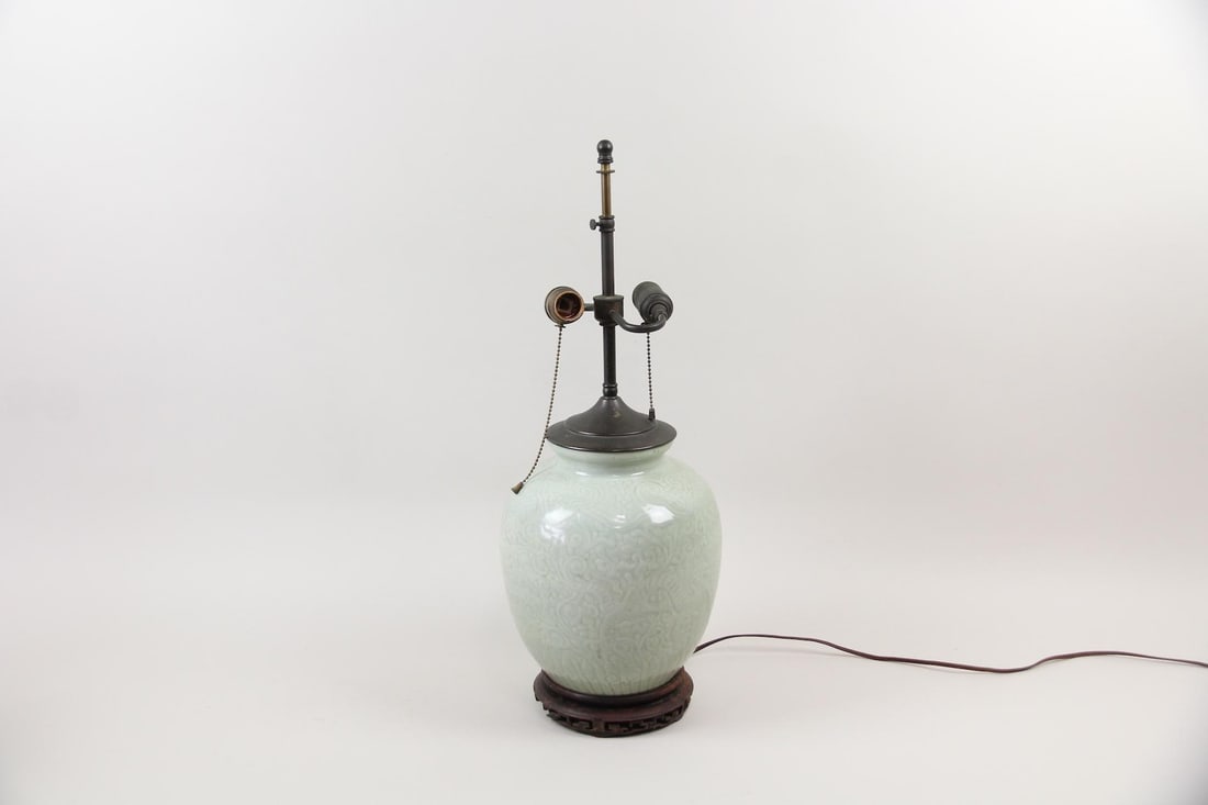 Chinese Celadon Glazed Porcelain Vase lamp: Chinese Celadon Glazed Porcelain Vase lamp. It features a nice soft green tone to the celadon glaze. It appears to be dark bronzed hardware.. Dimensions are 24.25 in h x 9 in w x 9 in d. Condition is 